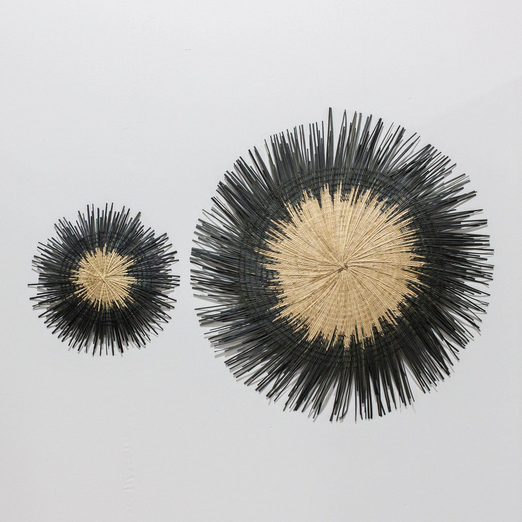 Two Usiku Woven Wall Art pieces with a natural enter and black indigo edging.